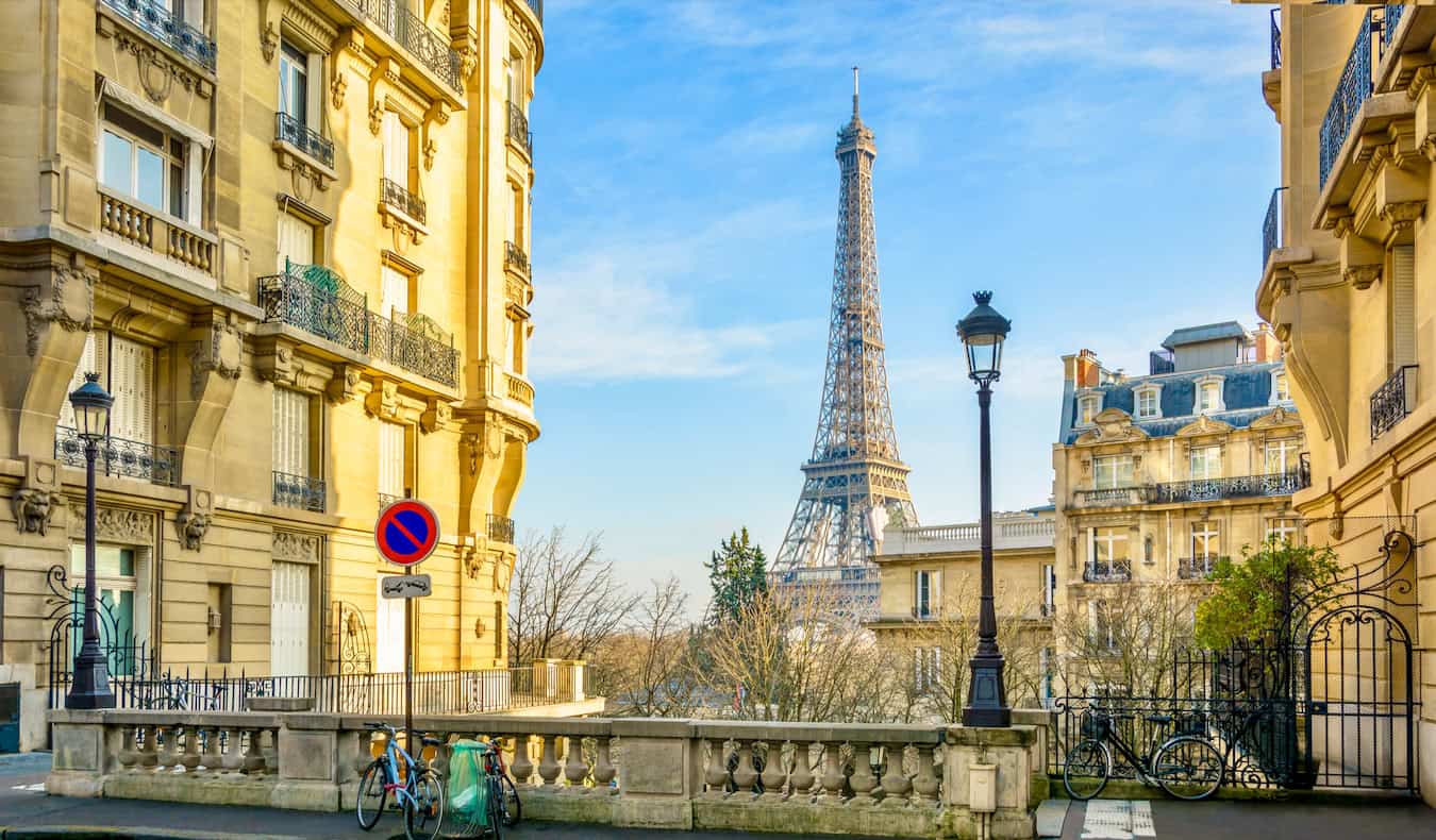 A quiet street in sunny Paris, France with the famous Eiffel Tower in the background