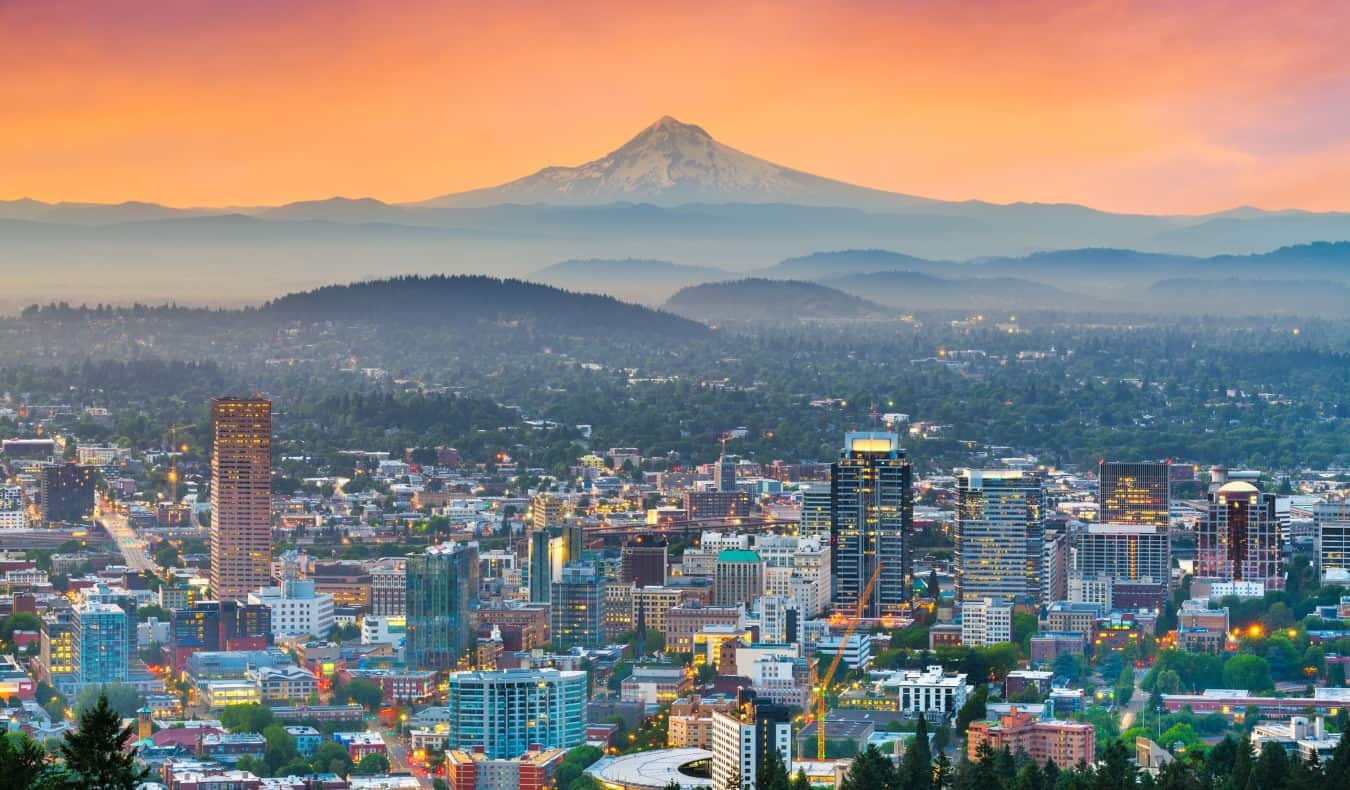 A colorful pink sunset over Portland, Oregon, USA, with Mount Hood in the background