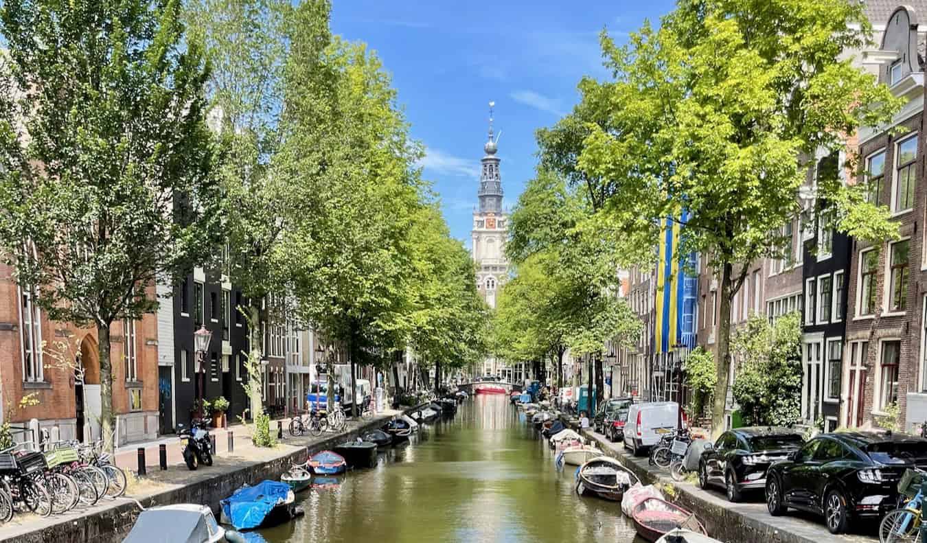 One of the many quiet, scenic canals in beautiful Amsterdam, Netherlands on a sunny summer day