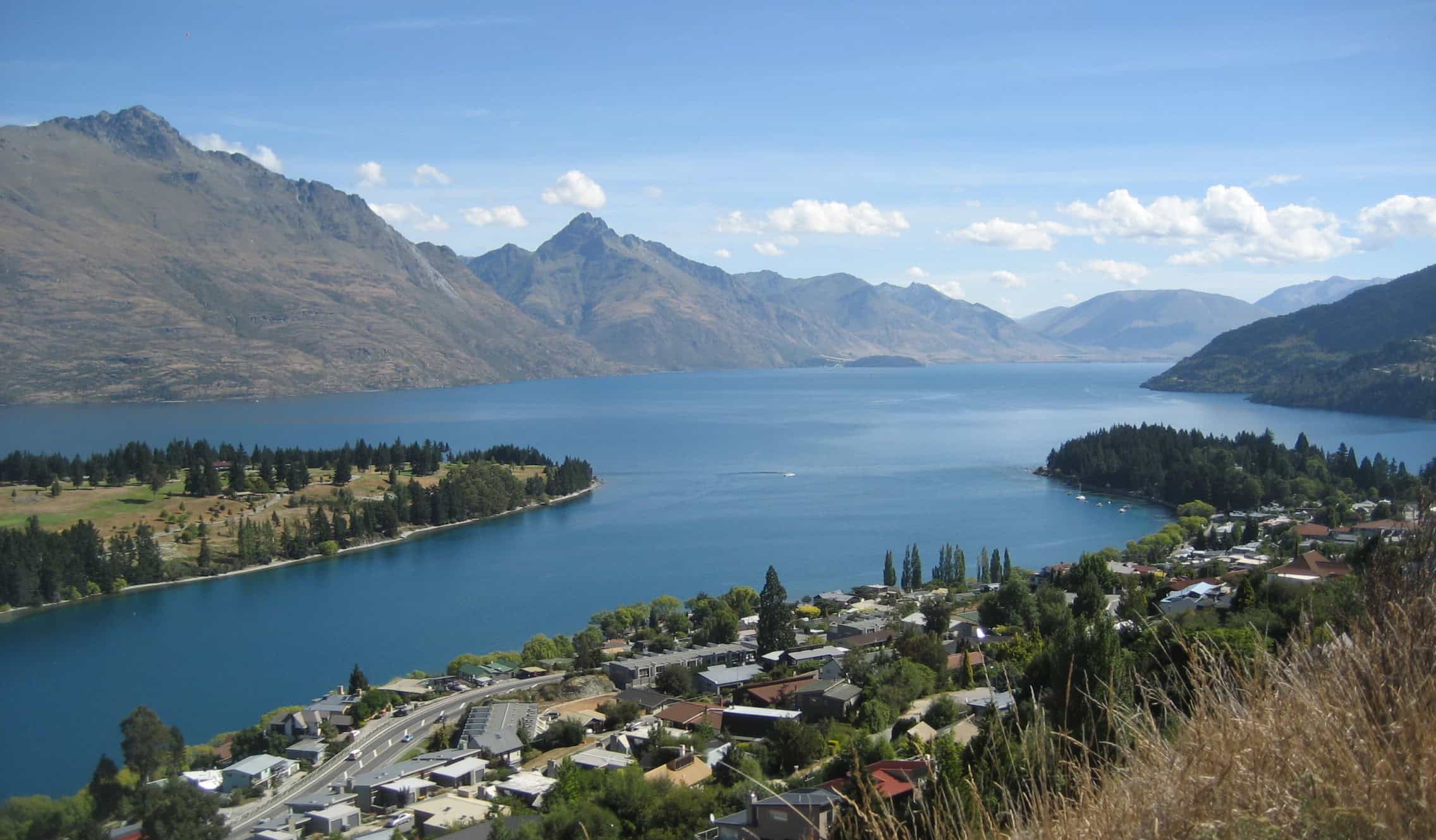 The town of Queenstown on a large lake with mountains in the background on New Zealand's South Island