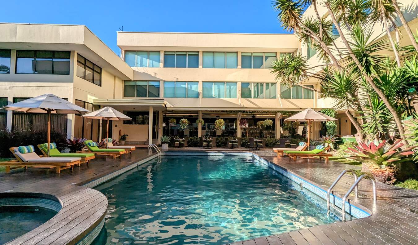 A pool surrounded by loungers at a hotel in San Jose, Costa Rica