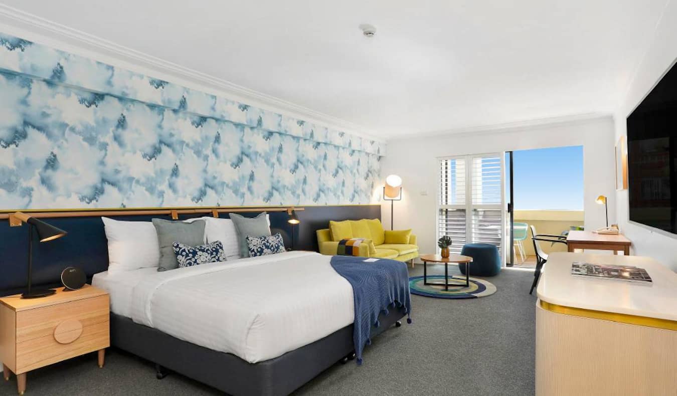 A large hotel room with ocean-influenced wallpaper the Coogee Bay Hotel in Sydney, Australia