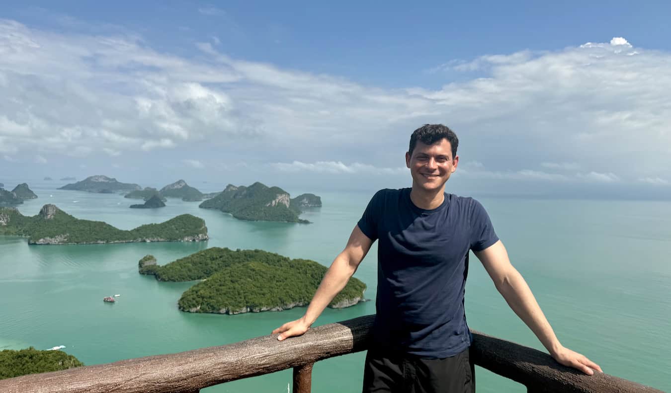 Nomadic Matt posing for a photo overlooking the beautiful islands of Thailand