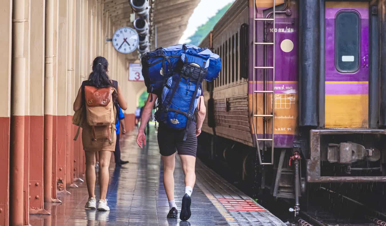 A pair of young backpackers in Chiang Mai getting ready to board a train