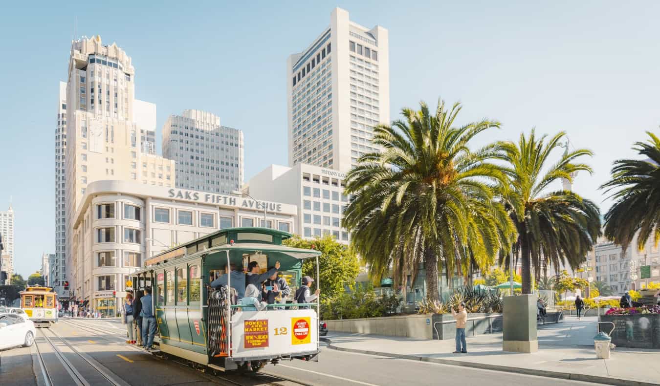 A cable car passes in front of Union Square in San Francisco, USA