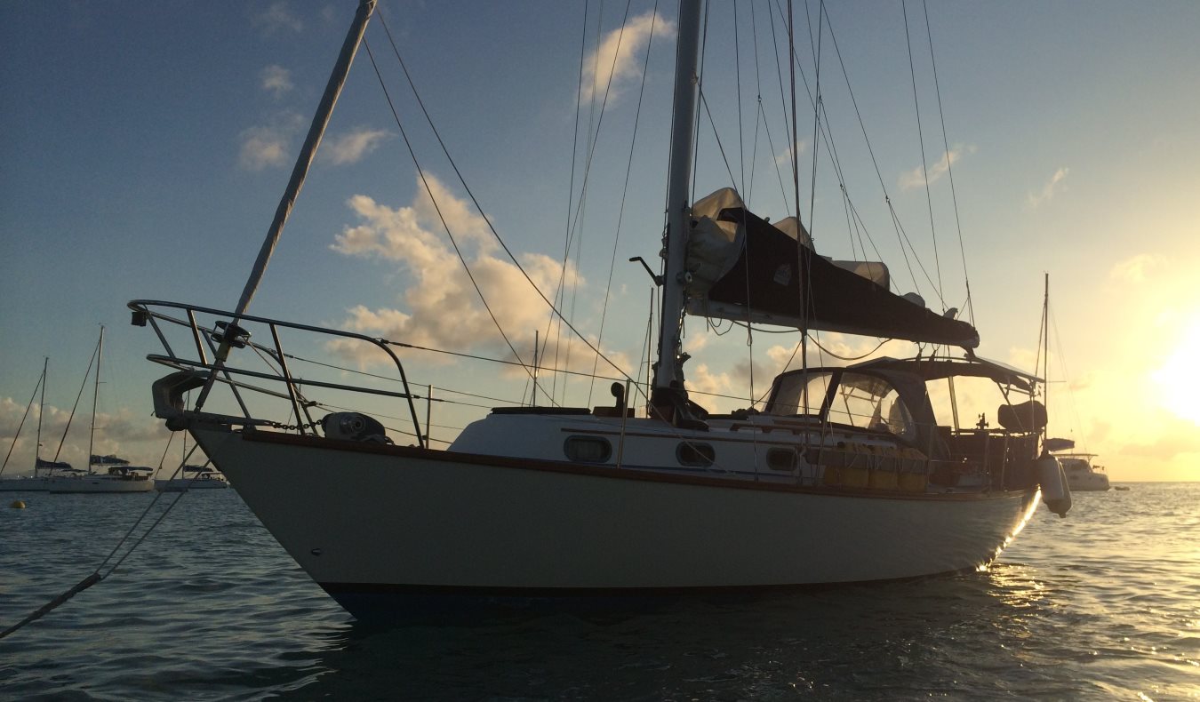 A yacht in the water at sunset