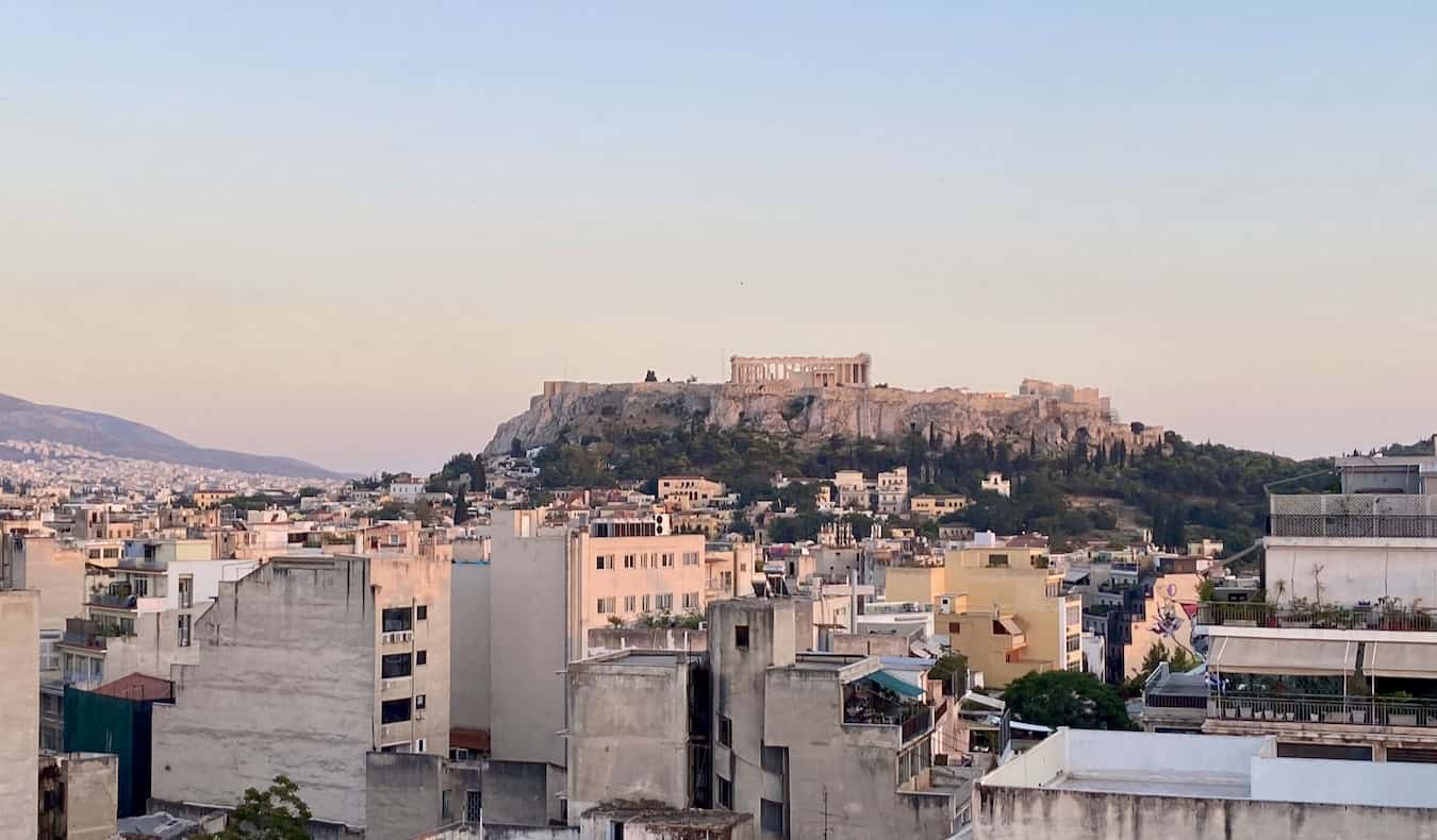 The Parthenon in Athens, Greece as seen from across the city at sunset