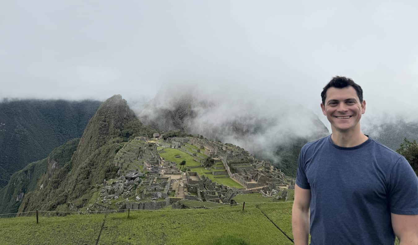 Nomadic Matt posing for a photo at the Wonder of the World Machu Picchu