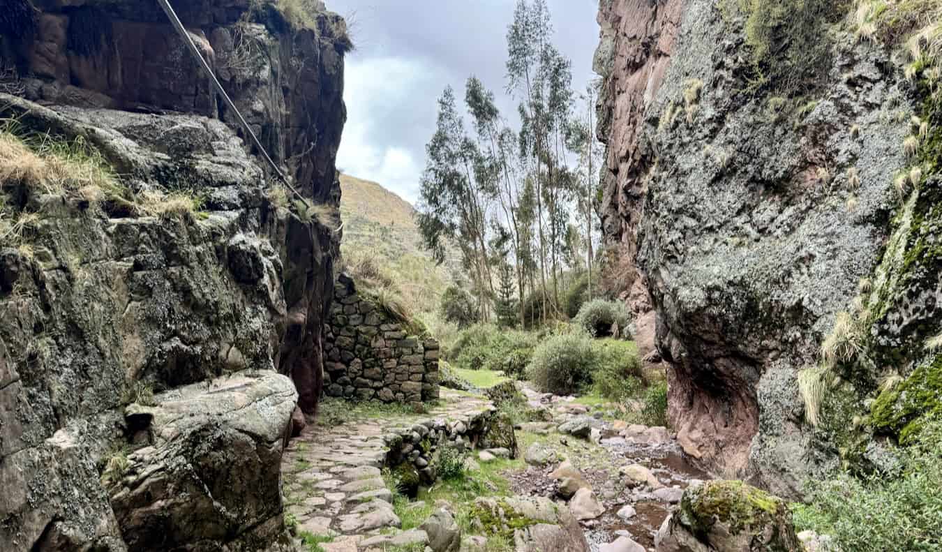 A narrow, rocky trail with Inca ruins in Peru