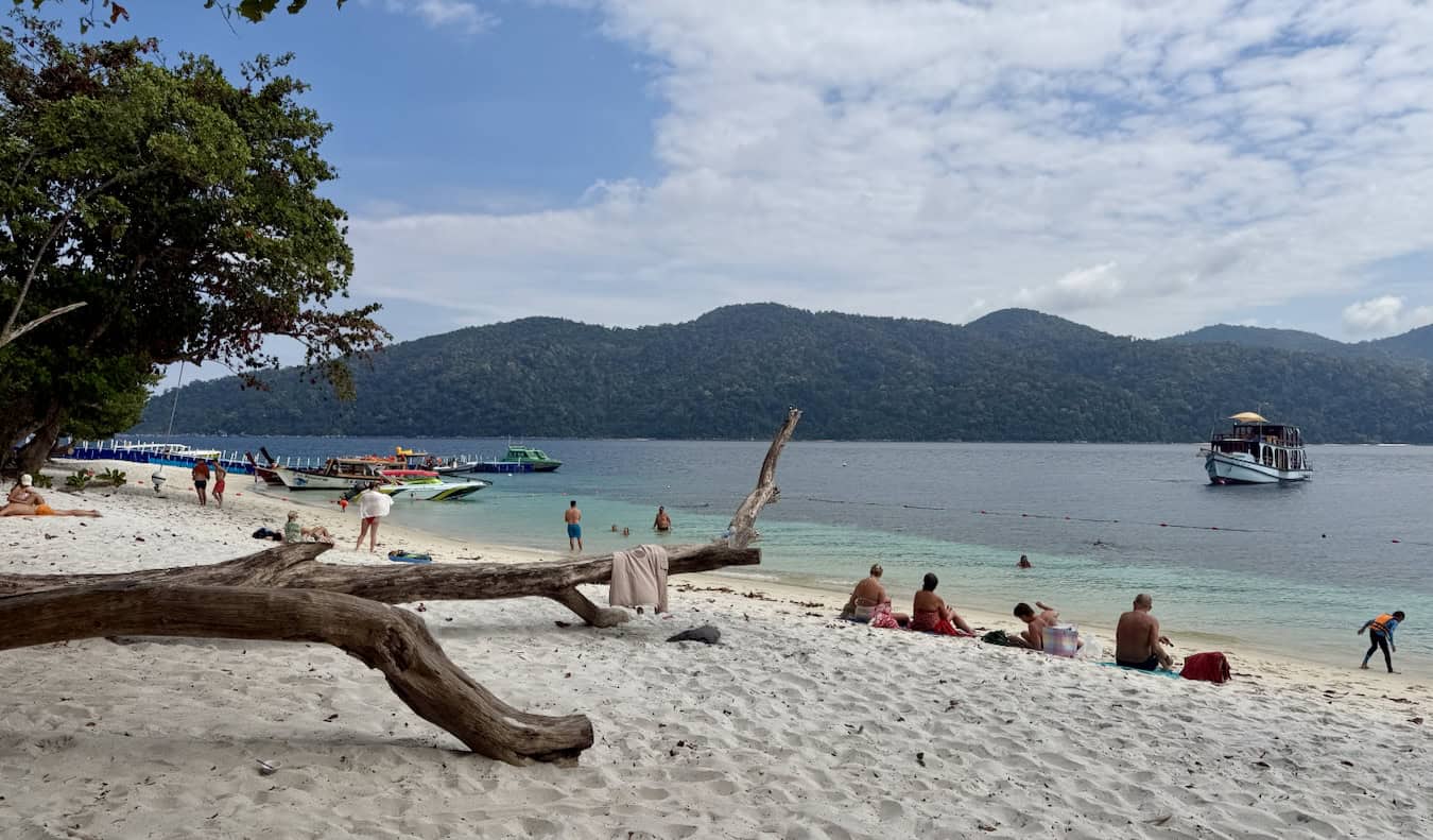 Tourist and boats on Ko Rawi in Thailand on a beach