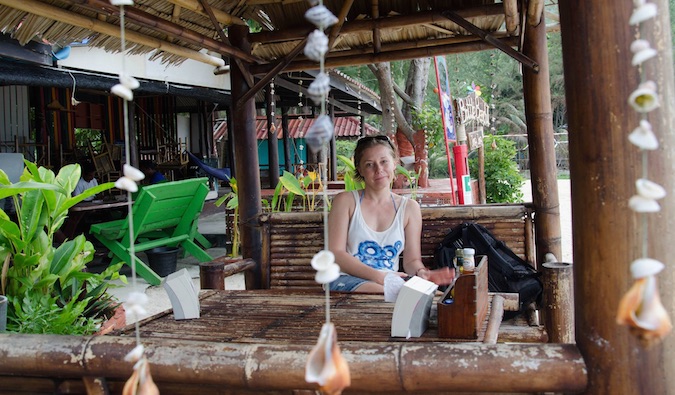 Solo female traveler sitting in a hotel lobby abroad