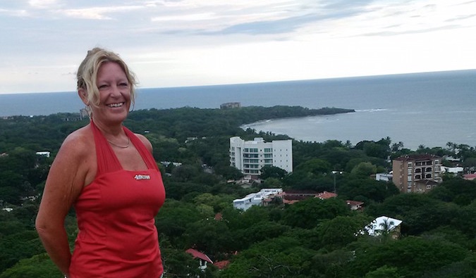 Woman posing infront of the landscape during her global travels