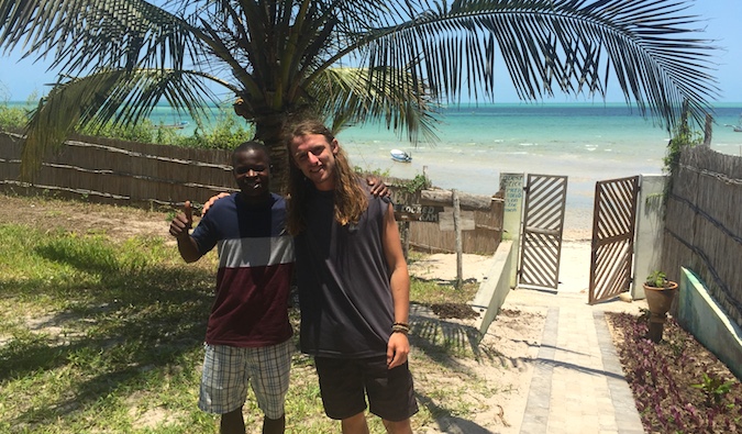 Two travelers posing for a photo in Tofo, Mozambique