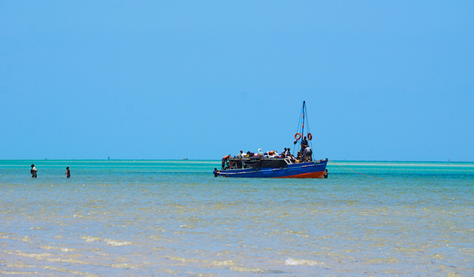 Hitchhiking on a boleia boat on the water in Mozambique, Africa