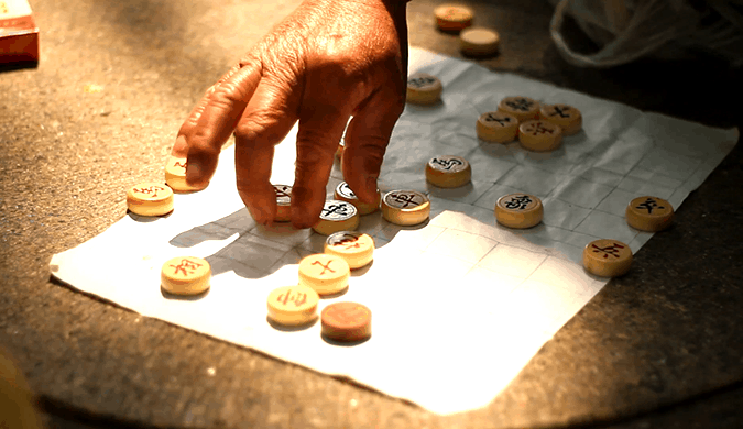 Locals gambling and playing a complicated Chinese street game