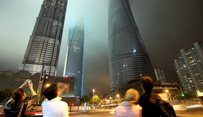 Expats staring at the towering skyline at night in China