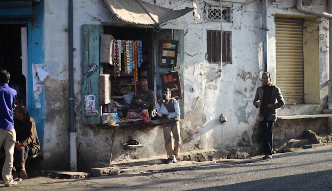 A small and run-down Indian shop at sunset in India