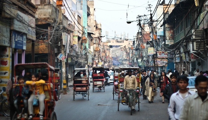 People and rickshaws filling the busy streets of India