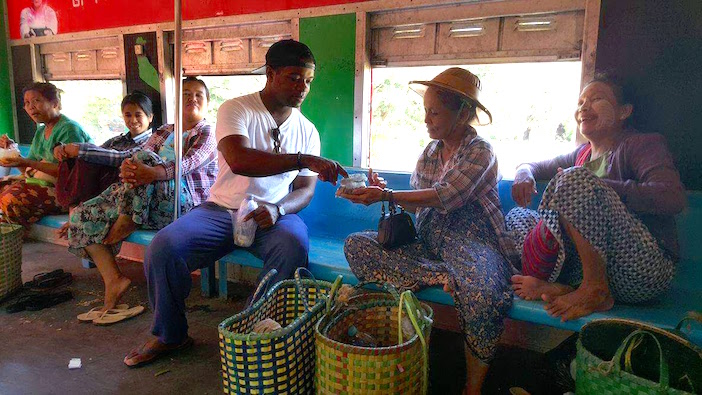 A black solo traveler at a market in Southeast Asia