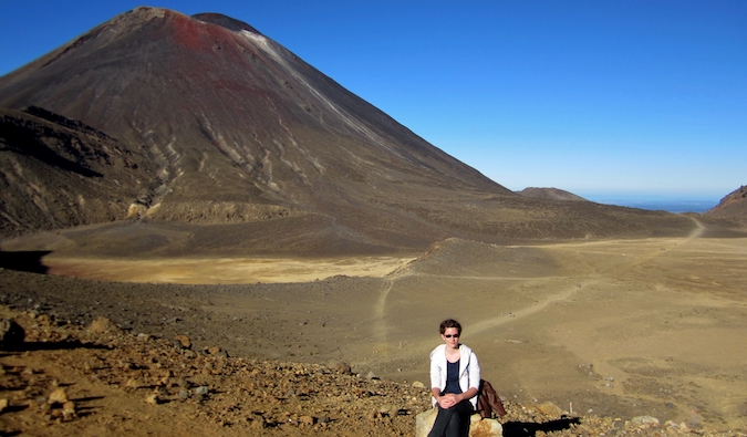 Angela posing near a large mountain in New Zealand