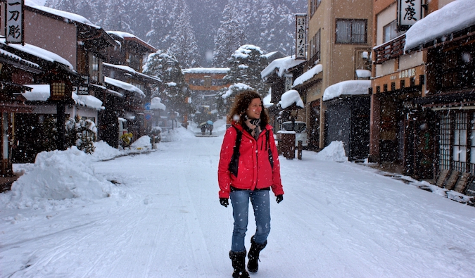 Angela walking in a snowy town