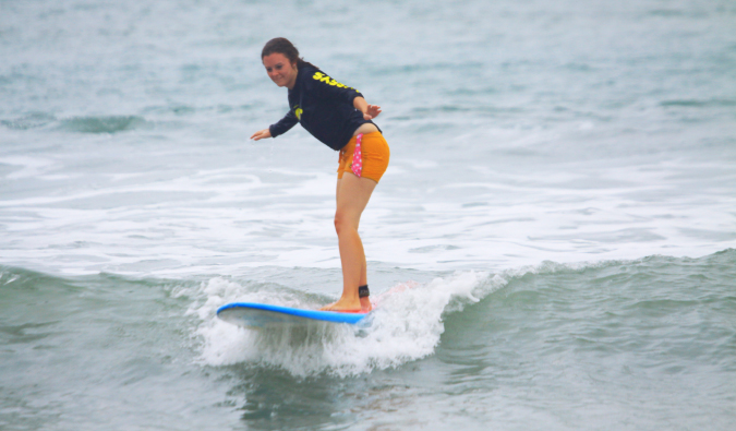 Solo female traveler learning to surf in Bali Indonesia