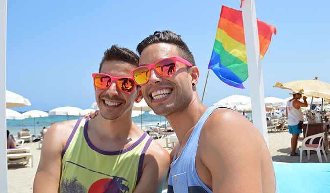 auston and david from two bad tourists posing on a beach in summer