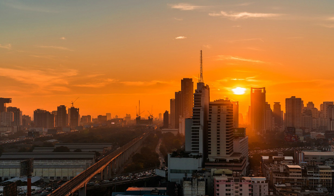 A bright orange sunrise over Bangkok