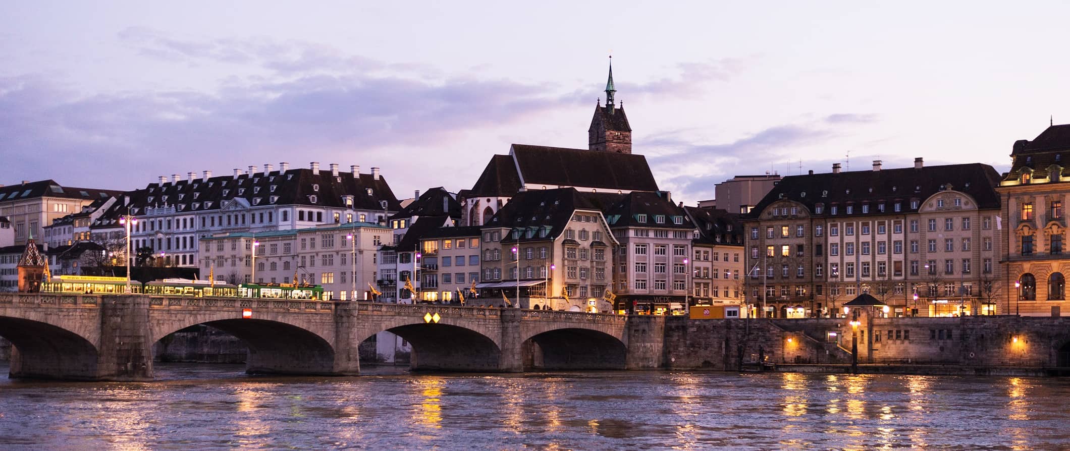 The bridge over the Rhine River in Basel with traditional historic buildings in the background