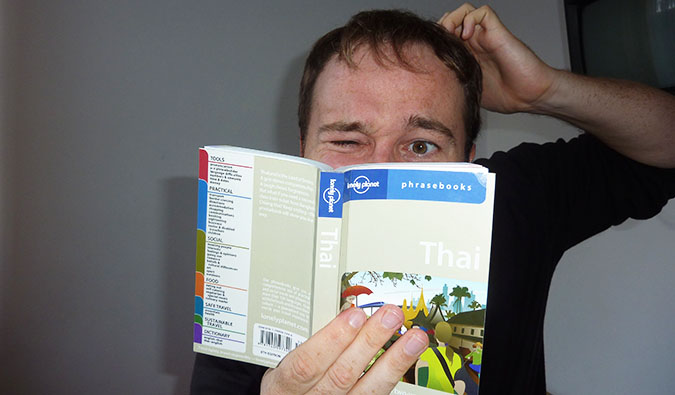 Benny studying a Thai phrasebook