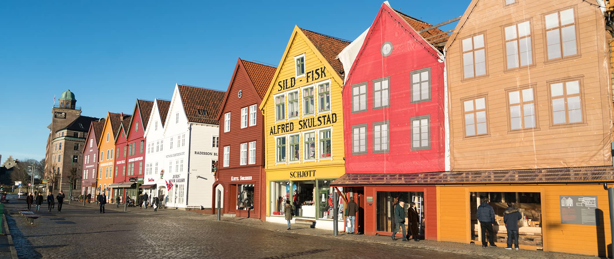 A row of colorful old buildings in Bergen, Norway on a sunny summer day