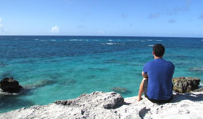 Nomadic Matt looking out onto the clear blue water in Bermuda