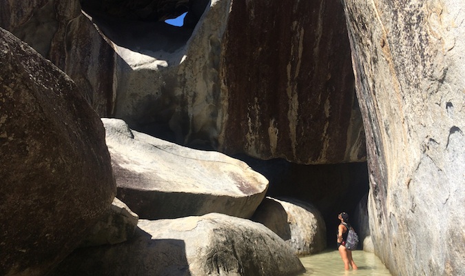 A person exploring the Baths, a rock formation in the Virgin Islands