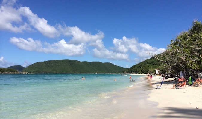 People swimming and relaxing on the beach on Cinnamon Bay, USVI