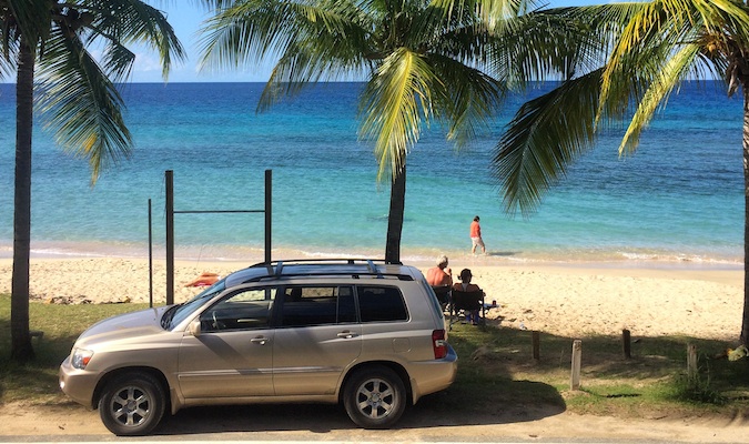 A car parked near the beautiful beach at Cane Bay in the USVI