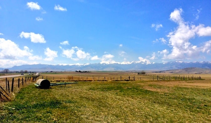 A flat, sparse farmyard in rural Montana during the summer