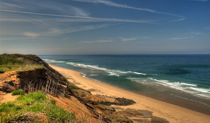 Waves crashing against a sunny beach in Cape Cod, Massachusetts