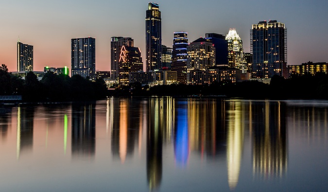 Austin, Texas skyline at dusk shining over the water