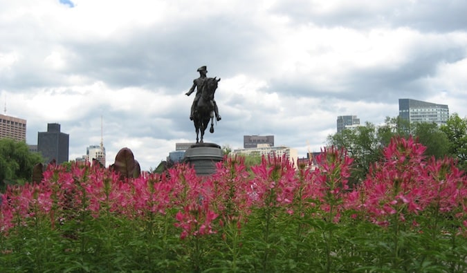 A historic statue surrounded by flowers in Boston, Massachusetts