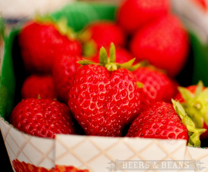 An up-close shot of a box of red strawberries