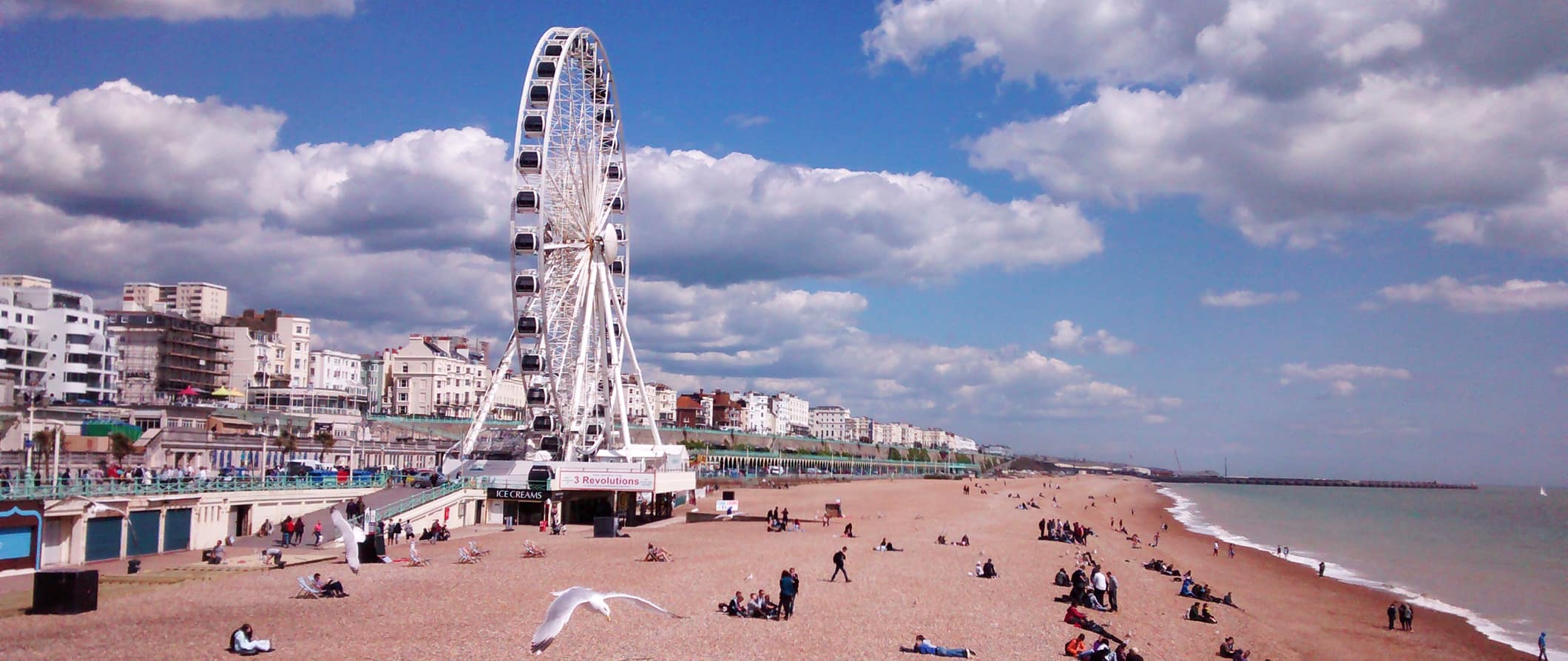 a view of Brighton Beach and the Ferris wheel on the coast in sunny Brighton, UK