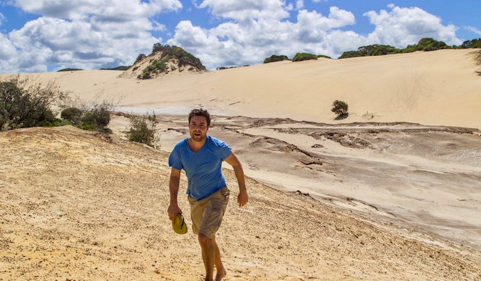 Brook Silva-Braga in the desert walking up a sand dune