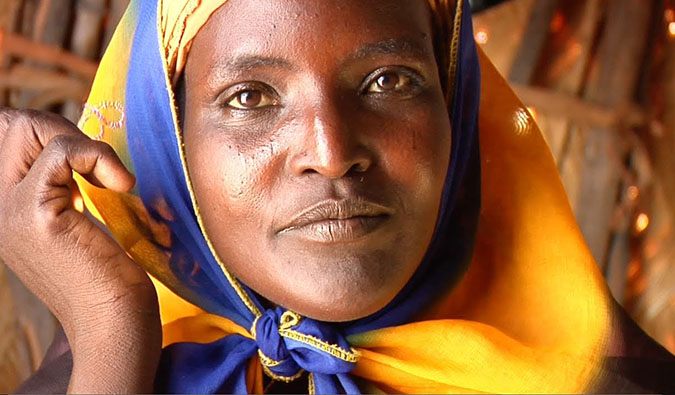 A woman from Africa looking at the camera during the filming of One Day in Africa