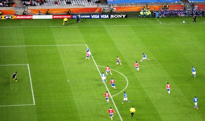 Players in the World Cup surrounded by cheering fans