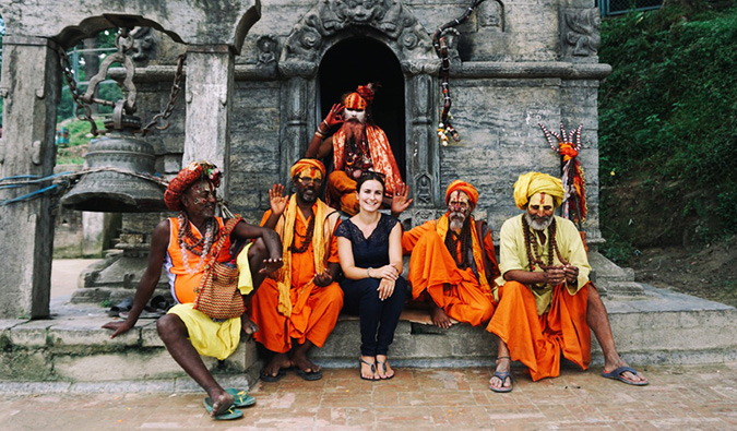 Celinne da Costa posing at a temple in India with some locals