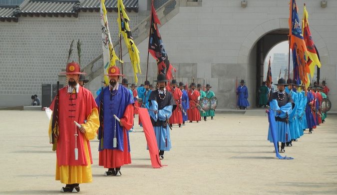 People in traditional colorful clothing walking around in South Korea