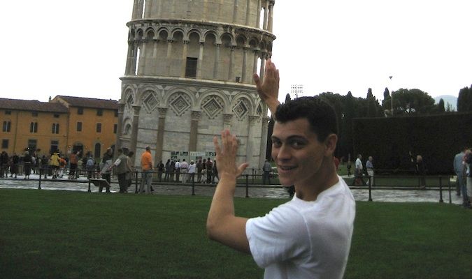 Matt pretending to hold up the Leaning Tower of Pisa in Italy