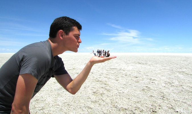 Nomadic Matt and travel friends posing like a tourist on a salt flat