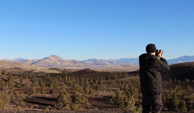 Vegan traveler Chris Oldfield taking a photo at a national park in the USA