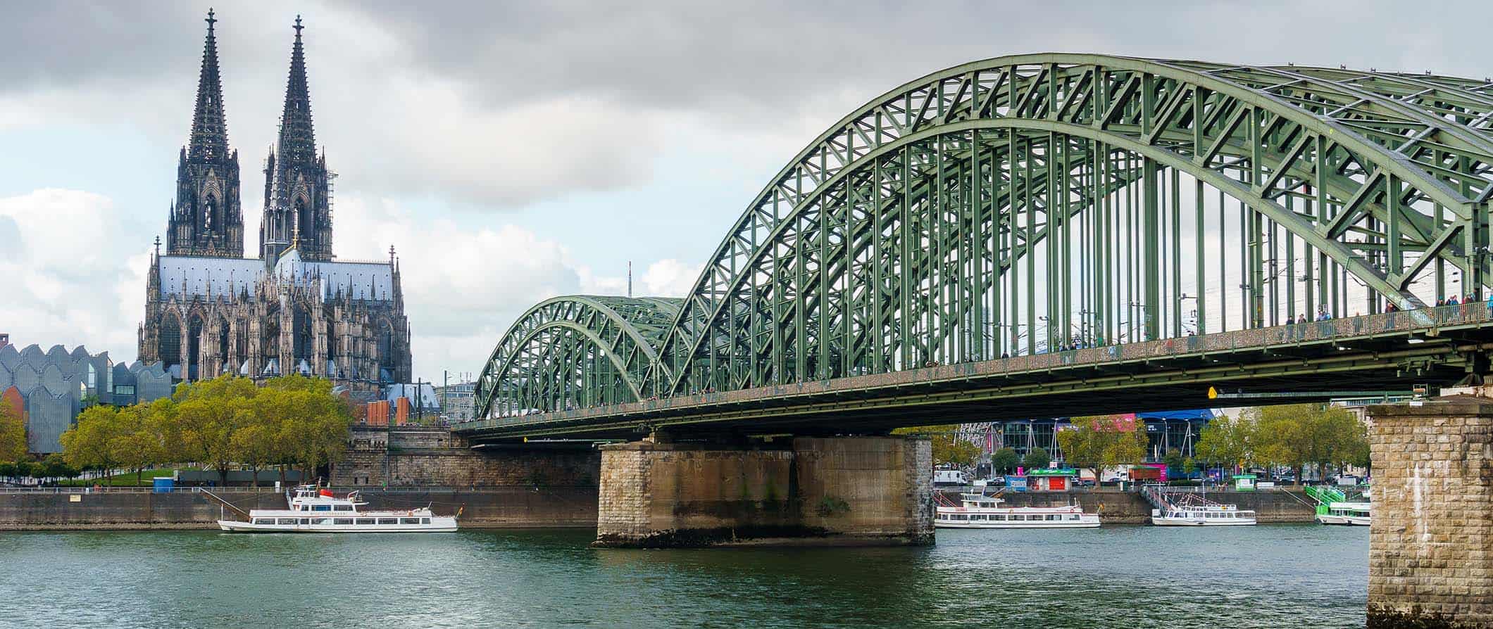 A view of the iconic cathedral and bridge in cloudy Cologne, Germany